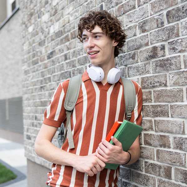 High school boy with striped short and headphones