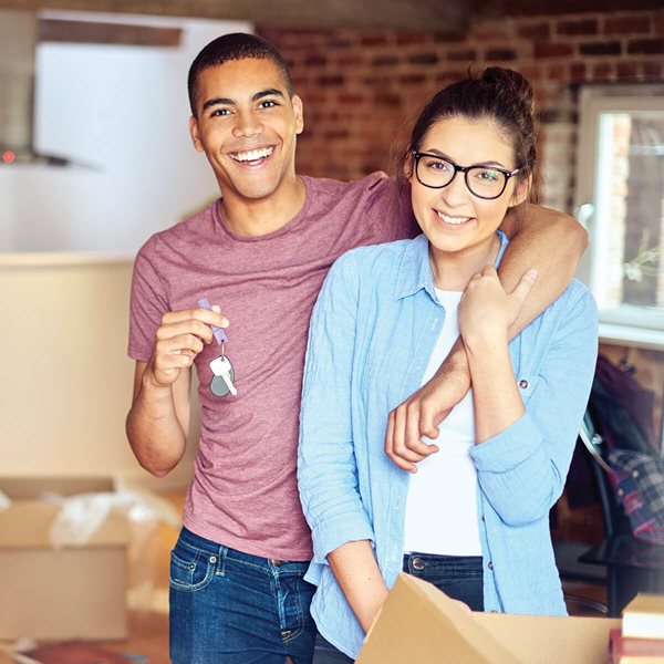 Young couple with keys to new house