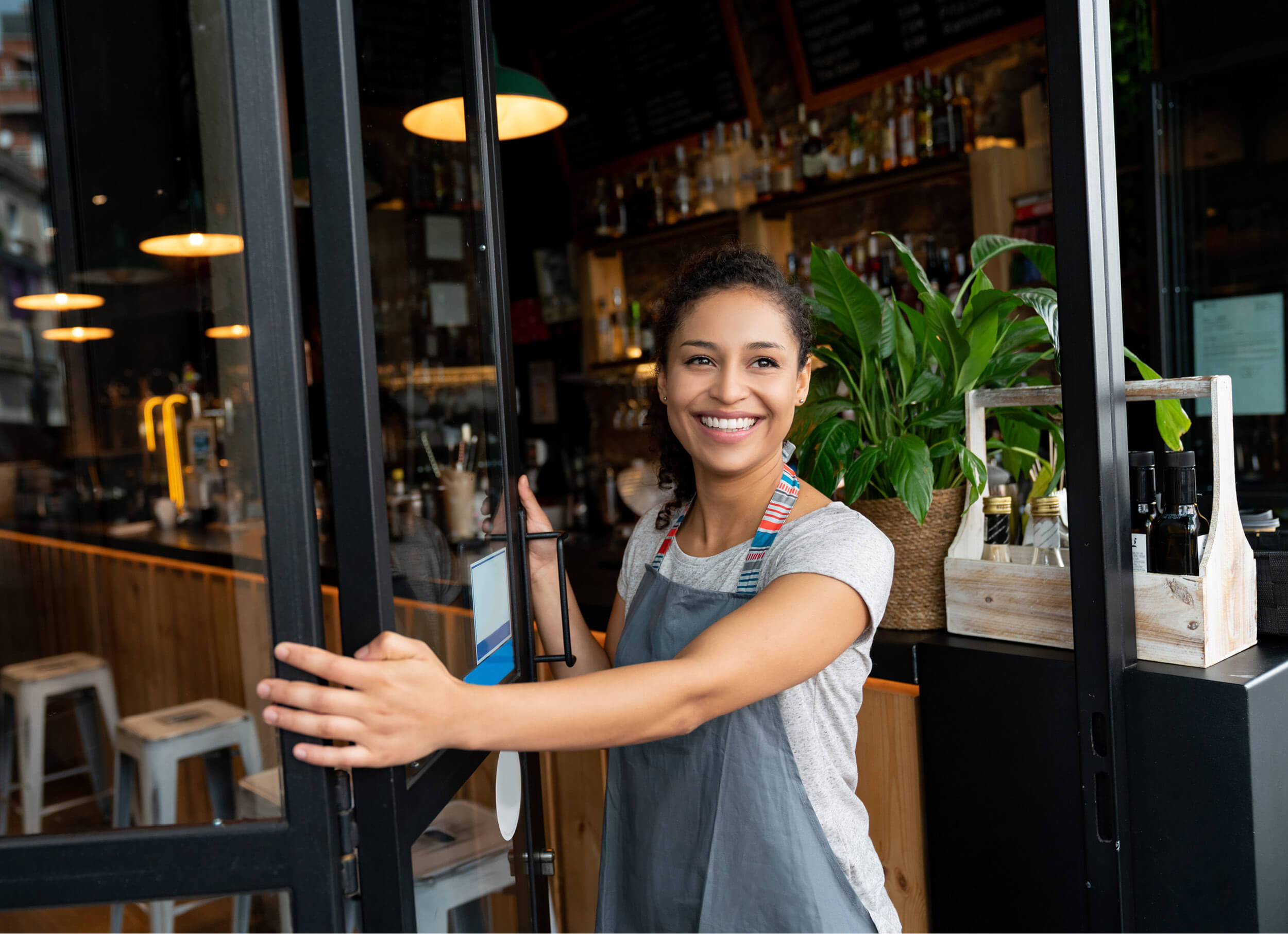 Two children riding in the back of a red car.
