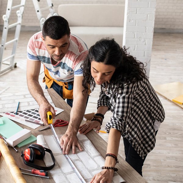 happy couple looking at each other with painting supplies