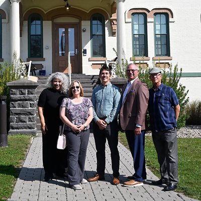 USB CEO with others in front of a historic building