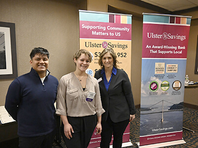 Chamber attendees in front of USB Community Banners